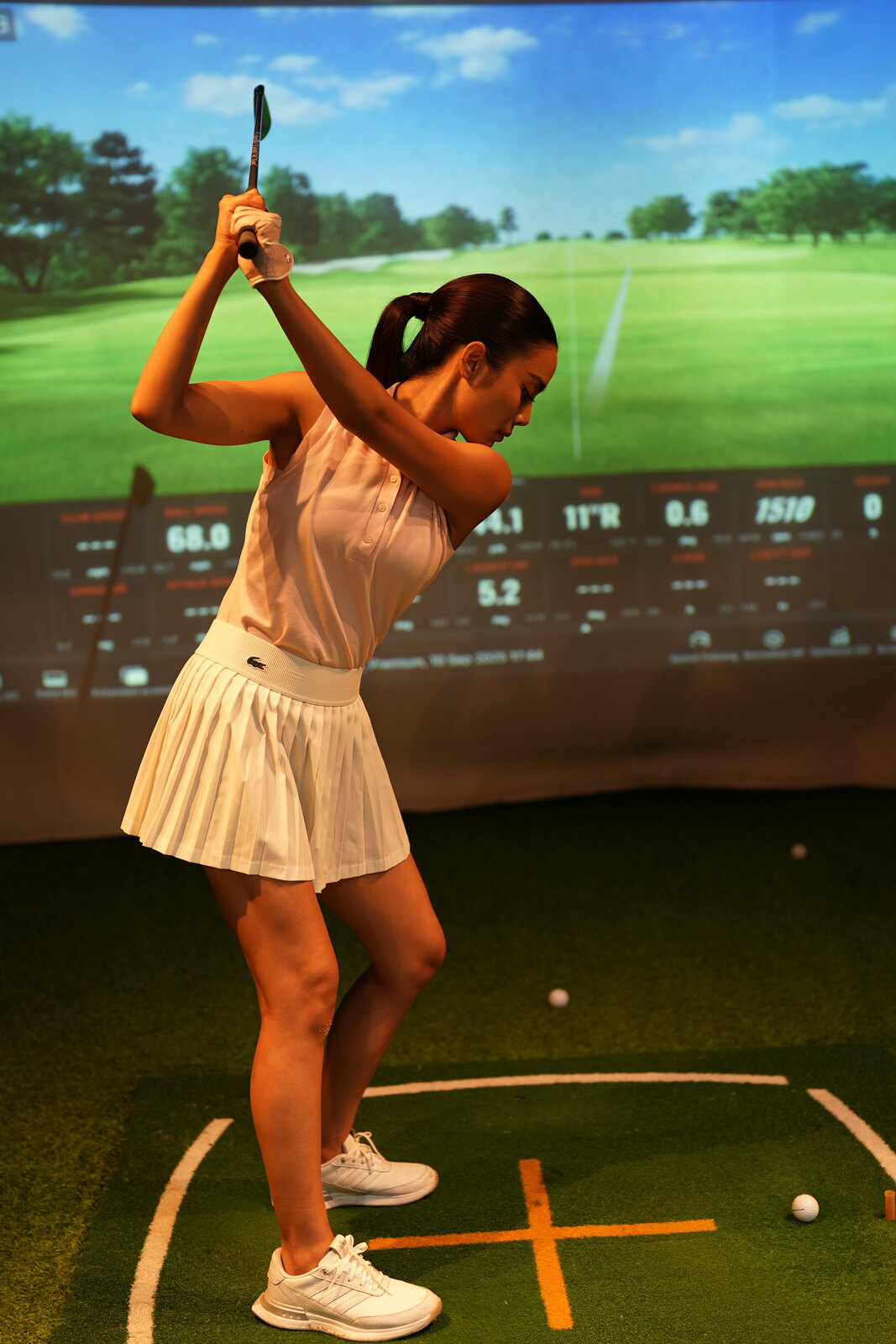 A golfer practising with simulator technology at the academy